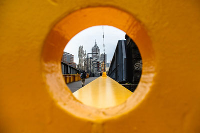 A view of the city through an orange window.