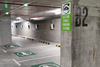 A photograph of electric vehicle charging stations in a car park.