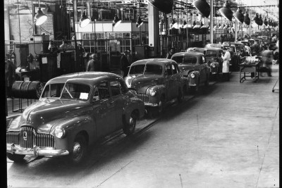 Cars lined up in a factory.