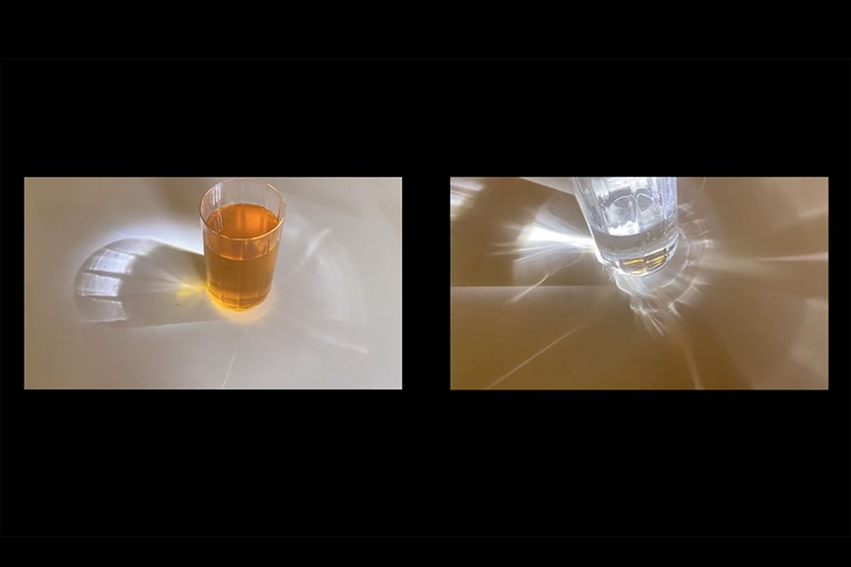 Two liquid-filled glasses with light refracting through them