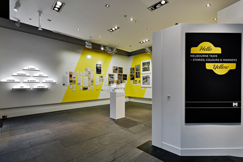 Entrance to the exhibition featuring large black and yellow sign