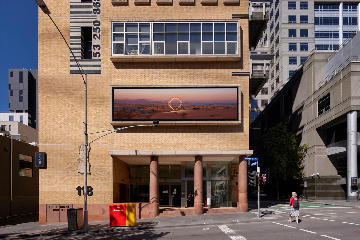The artwork installed on the building, viewed from directly across the street.