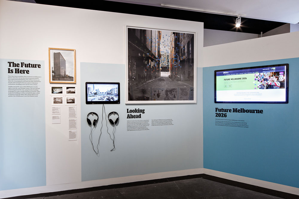 Exhibits titled: 'The Future is Here', 'Looking Ahead' and 'Future Melbourne 2026' comprising photos, a small screen with headphones attached and large touchscreen