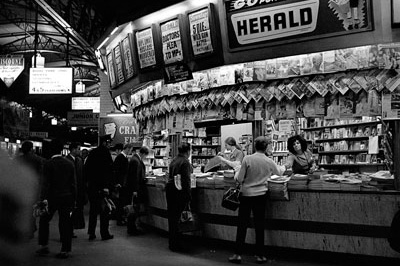 Black and white photo of news stand