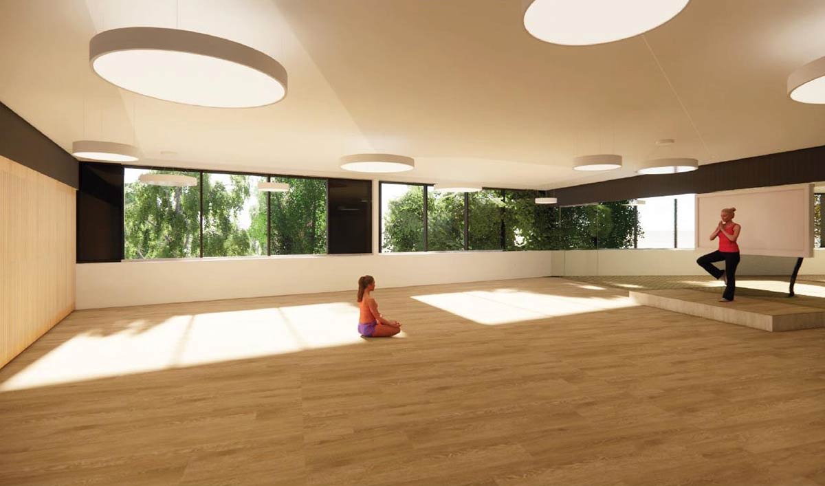 Artist impression of the flexible space being used for yoga/meditation. The space is bright with overhead lighting and sunlight, and has large windows with lush greenery outside.