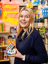 Marnie Hipkins in the Mind Games shop, holding a Rubik's cube.