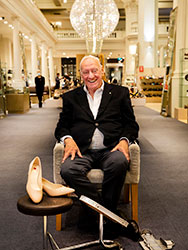 Peter Sheppard seated in his shoe store.