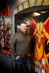 Adam Picket standing in front of the entrance to Dungeon of Magic, a large dragon is painted on the door.