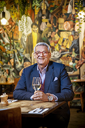 Smiling man with glass of wine in Italian restaurant