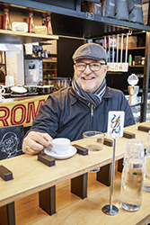 Smiling man with coffee in cafe