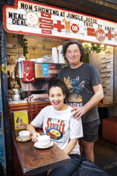 Smiling man and woman in laneway cafe