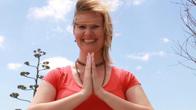 Smiling woman in prayer pose