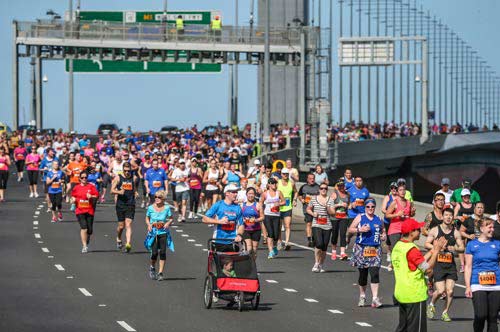 Large group of 'Run for the Kids' participants running on the Bolte bridge