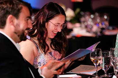 Guests reading the program at the Melbourne Awards gala ceremony