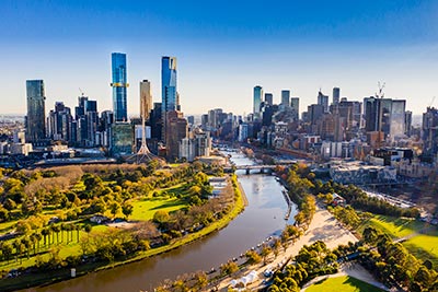 Aerial view of the Melbourne CBD and Yarra River under a clear blue sky
