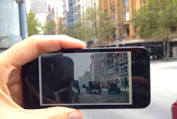 Phone held up to street showing image from past