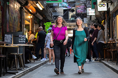 Two women walking along Melbourne laneway