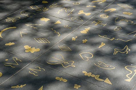 Brass hieroglyphics inlaid in bluestone pavement