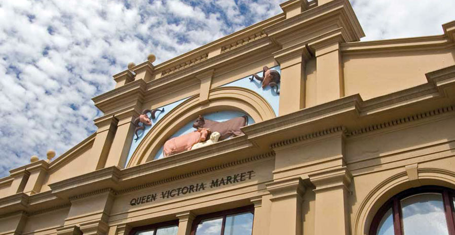 Queen Victoria Market building facade with livestock models above the entrance sign.