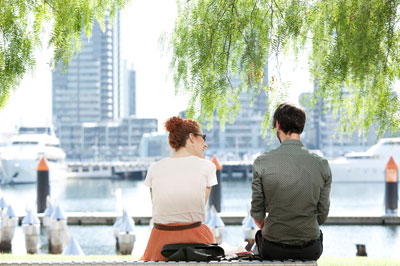 Couple on park bench overlooking water