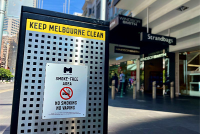 A bin with a sign that reads keep Melbourne clean, no smoking or vaping.