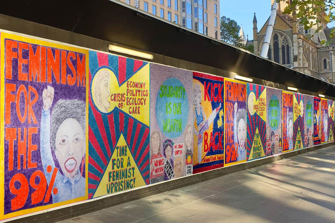 Colourful hand-drawn posters with feminist messages and images. The posters are mounted on hoarding for a Metro Tunnel construction site