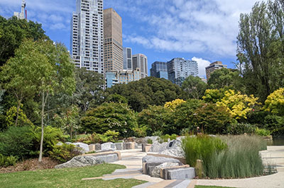 Gardens with city buildings in the background.