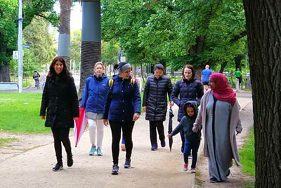Women walking through a park together.
