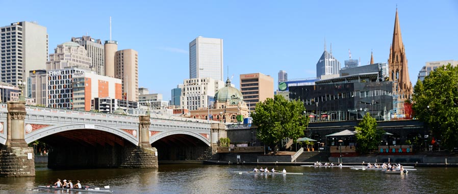 City scape with CBD buildings and kayaks rowing on the Yarra River, near Princes Bridge