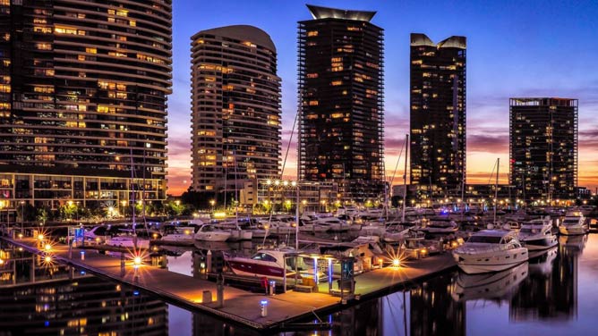 Yarra's Edge Marina pontoons and buildings lit up at dusk