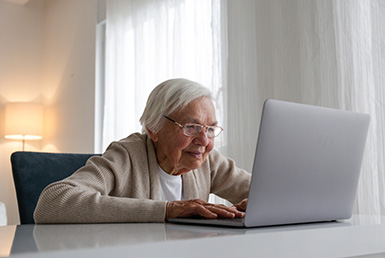 older person looking at a laptop