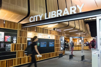 person walking through the foyer of city library in melbourne